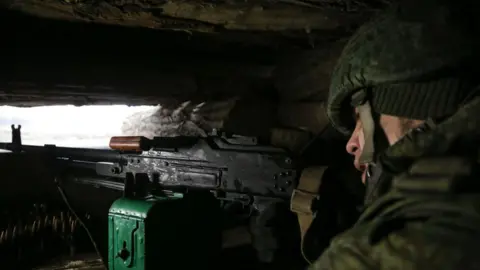 Getty Images A serviceman of the Peoples Militia of the Donetsk People's Republic is seen in a trench shelter on the line of contact between the Ukrainian government forces and the forces of the Donetsk People's Republic in the town of Yasynuvata