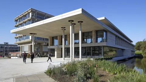 Getty Images The Silberrad building at the University of Essex's Colchester campus. It is pictured on a sunny day with students walking in front of it. The building is cream and has columns in front of its many windows. In the background are other campus buildings