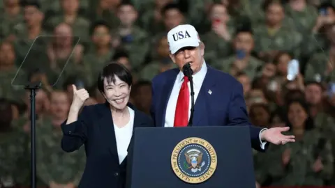 U.S. President Donald Trump speaks as Japanese Prime Minister Sanae Takaichi gestures