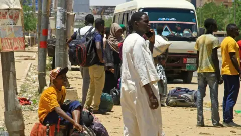 Getty Images Civilians wait to flee Khartoum