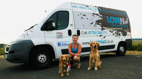 Caroline Donoghue Caroline Donoghue with her dogs outside her grooming van