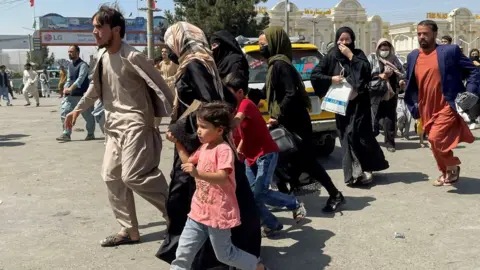 Reuters People try to reach airport