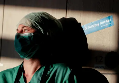 Stephanie Lecocq / EPA-EFE An intensive care nurse takes a break in Brussels, Belgium, 24 April 2020