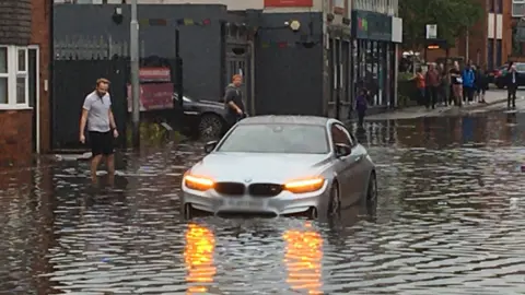 BBC Car stuck in flood water