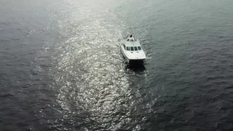 BBC A photo of a boat