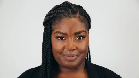 A happy black latin girl with green Box Braids hairstyle smiling