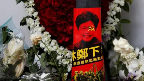 Reuters Picture of Carrie Lam with hammer and sickle across her face