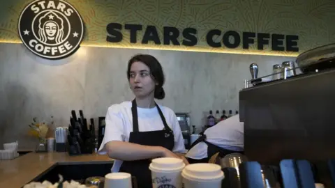 Getty Images A worker prepares coffee at the newly-named Stars chain.