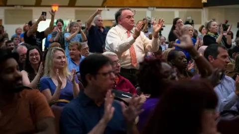 Caroline Brehman/Getty Images Attendees cheer on Ms Luria