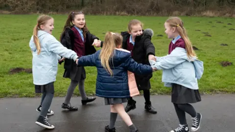 Getty Images A group of children play outdoors at Glan-Yr-Afon primary school in Cardiff