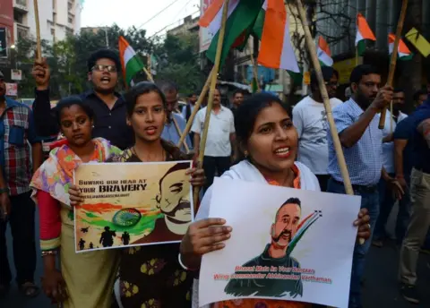 Getty Images People holding posters of Wing Commander Abhinandan Varthaman celebrate his return at a rally in Kolkata on 2 March 2019.