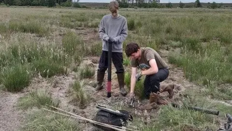 Ash Murray Installing ground water monitoring tubes on Grimston Warren