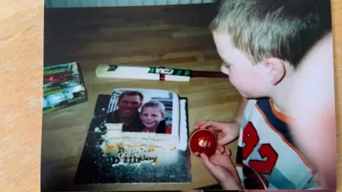 Robbie James Robbie as a child with a photo