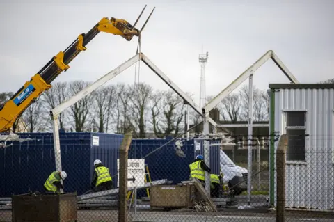 PA Media Construction workers build a border control post at Larne Harbour