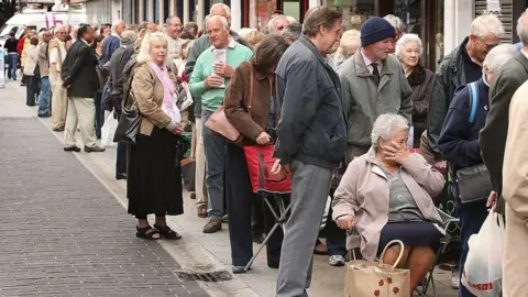 Getty Images Customers queue outside Northern Rock