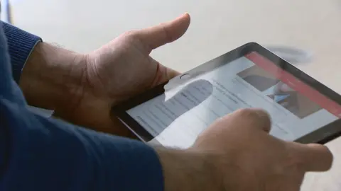 man holding a tablet