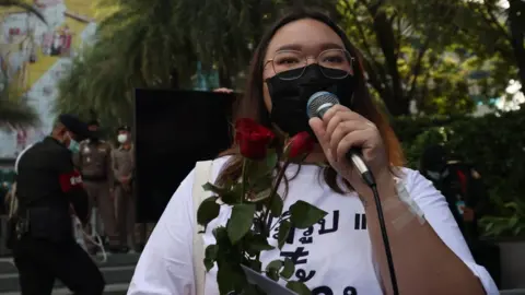 AFP Political activist Panusaya "Rung" Sithijirawattanakul speaks outside the Constitutional Court of Thailand in Bangkok on November 10, 2021.