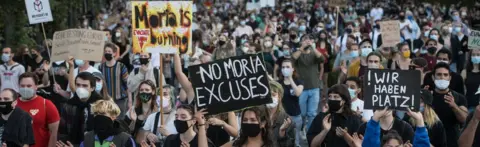 Getty Images Protesters march during a demonstration for the evacuation of all migrant camps in Greece