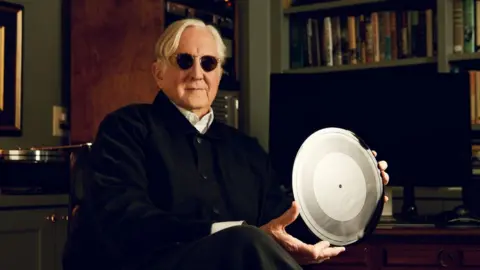 Jason Myers T Bone Burnett with the Bob Dylan disc