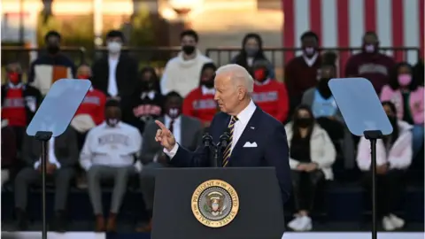 President Joe Biden points while giving a speech