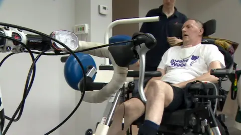 BBC David Collings sitting on a motorised bike