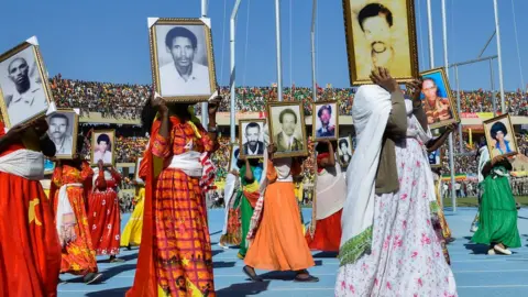 AFP People parade photos of their relatives who died during the Tigray People's Liberation Front's (TPLF) 17-year struggle against the military regime in Mekelle - 19 February 2020