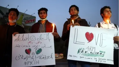 EPA Members of Pakistan youth council for interfaith harmony hold a candle light vigil for the victims of the attack at Kabul University in Islamabad, Pakistan, 04 November 2020.