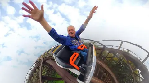 A super fan takes his 6,000th ride on a wooden rollercoaster after Covid delayed the milestone.