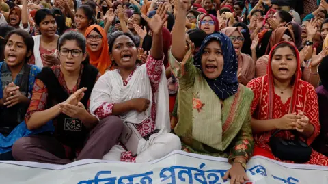 Reuters Students and job seekers shouts slogans as they protest to ban quotas for government job at Shahbagh Square in Dhaka, Bangladesh.