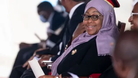 Getty Images Tanzania's new president, Samia Suluhu, attends a service honoring President John Magufuli on March 26, 2021