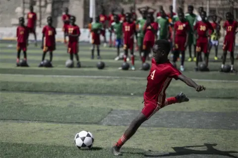 MOHAMED HOSSAM/EPA Children attend a soccer training session at 