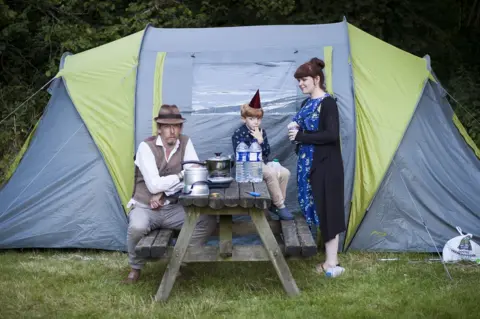Chrystal Ding Portrait of a family in front of a tent