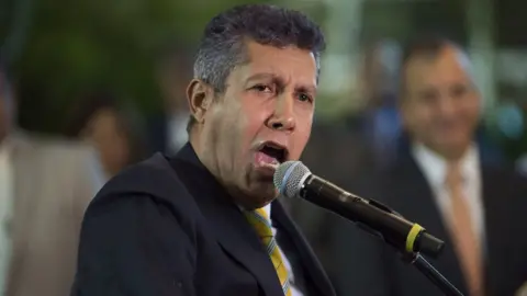 Getty Images Former Lara governor Henri Falcon addresses the media after submitting his presidential application in Caracas on February 27, 2018