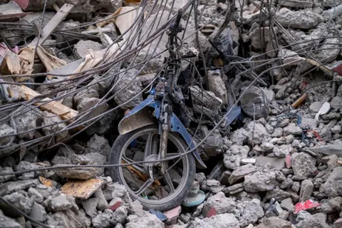 Reuters Parts of a motorcycle are seen in the rubble of a destroyed hotel in Les Cayes, Haiti on 16 August 2021