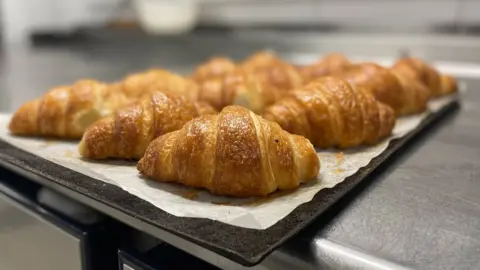 BBC Croissants sit on a tray ready for sale at a bakery in Paris