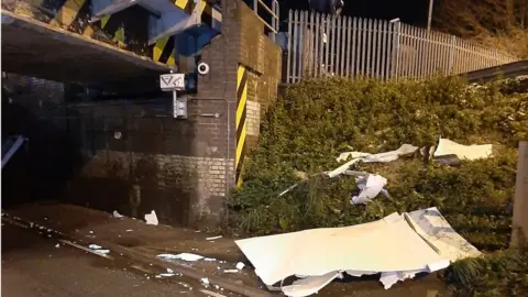 Cambridgeshire Constabulary Damage from crash strewn on side of road