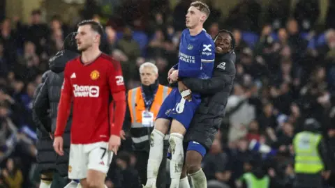 Cole Palmer celebrates with a teammate with Mason Mount looking on