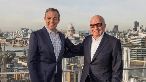 THE WALT DISNEY COMPANY HANDOUT Disney's Bob Iger and 21st Century Fox's Rupert Murdoch. If Murdoch is selling most of his $80bn company because he thinks it is too small to compete in entertainment, what is the future for other media organisations?