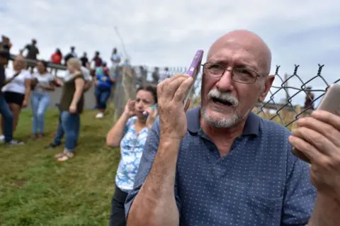 Getty Images Residents have flocked to working mobile phone towers to call family members overseas