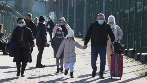 Reuters People walk at the border crossing between Poland and Ukraine