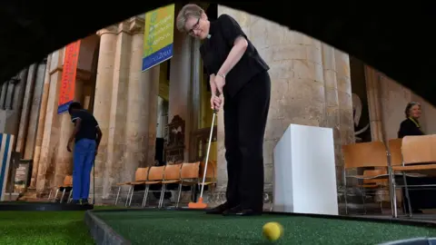 Getty Images Reverend Rachel Phillips plays golf