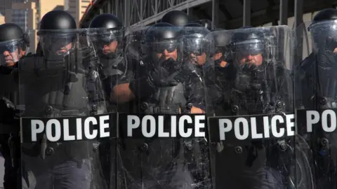 AFP US riot police officers take part in a border security drill at the US-Mexico international bridge