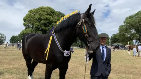 Stephanie Nelson/BBC Horse with groom