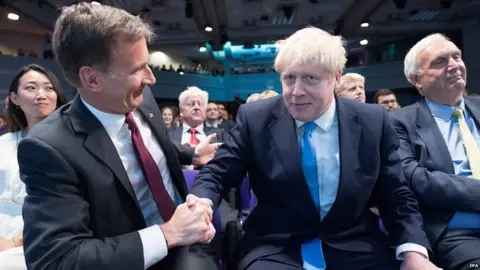 EPA Jeremy Hunt congratulating Boris Johnson after his victory