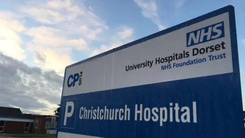 UHD NHS Trust University Hospitals Dorset sign