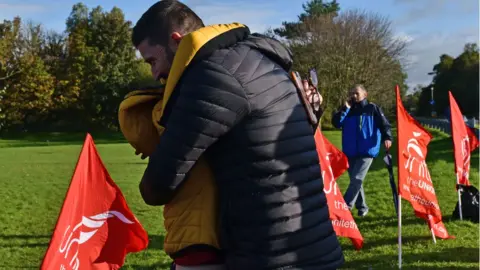 PAcemaker Wrightbus workers hug on hearing news of a deal