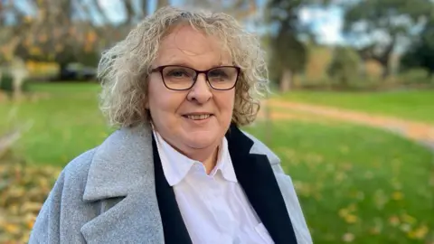 Jane Collins standing in a park