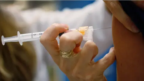 Getty Images A HPV vaccine being administered to a patient via injection