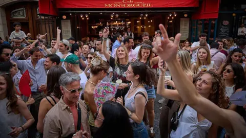 Revellers dance in the street during Fete De La Musique 2025 as bands and DJs play on streets across the French capital.