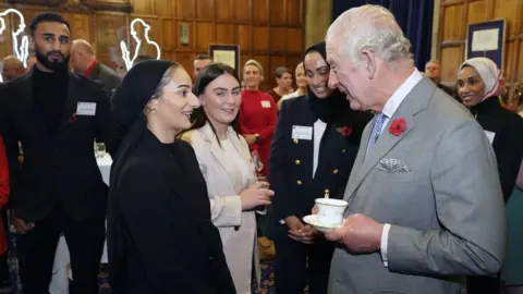 PA Media The King meeting Safiyyah Syeed at a reception with young leaders from across Bradford